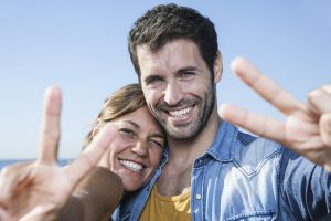 spain-mid-adult-couple-showing-peace-sign-smilin-2022-03-08-01-33-28-utc-min