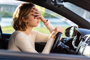exhausted-woman-driver-feeling-headache-keeping-h-2022-08-01-04-57-00-utc-min