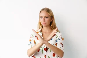 displeased-blonde-girl-showing-stop-gesture-at-cam-2023-11-27-05-27-22-utc