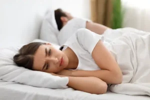 unhappy-wife-lying-with-husband-thinking-about-div-2023-11-27-05-30-48-utc